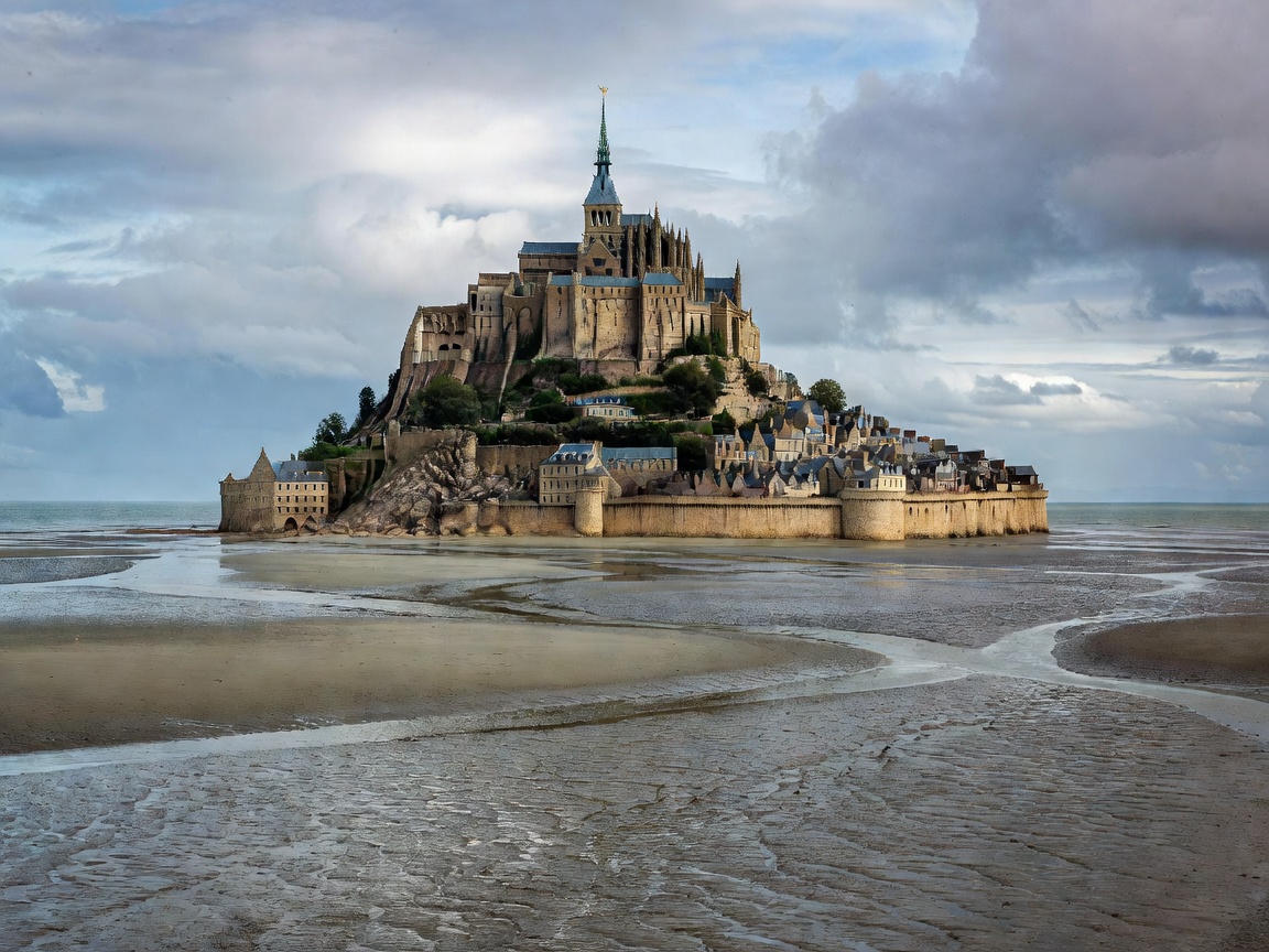 Mont Saint-Michel tidal island abbey towering over Normandy mudflats France